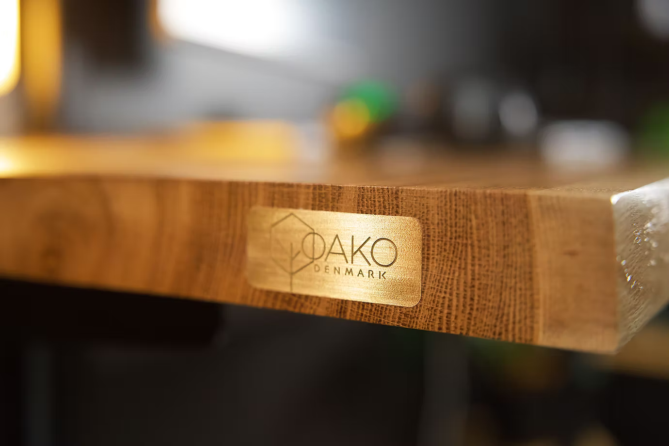 Wooden surface with a 'Dako Denmark' logo in the foreground, blurred background