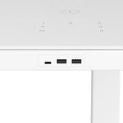 Close-up of a white electronic device with USB ports on a light gray background