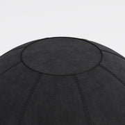 Black exercise ball on a light gray background
